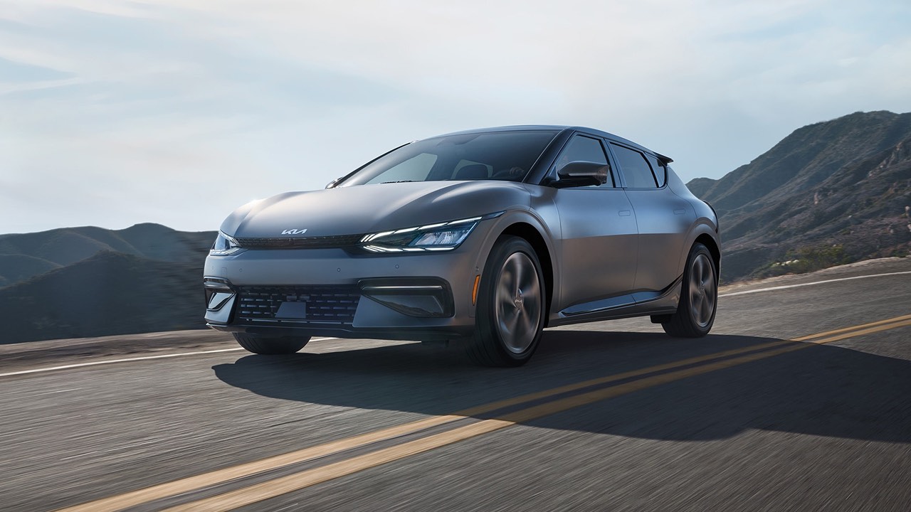 A grey Kia EV6 driving down the road