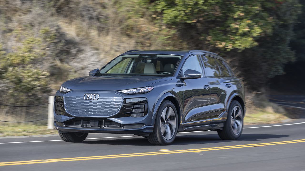 Black Audi Q6 E-Tron driving down a road