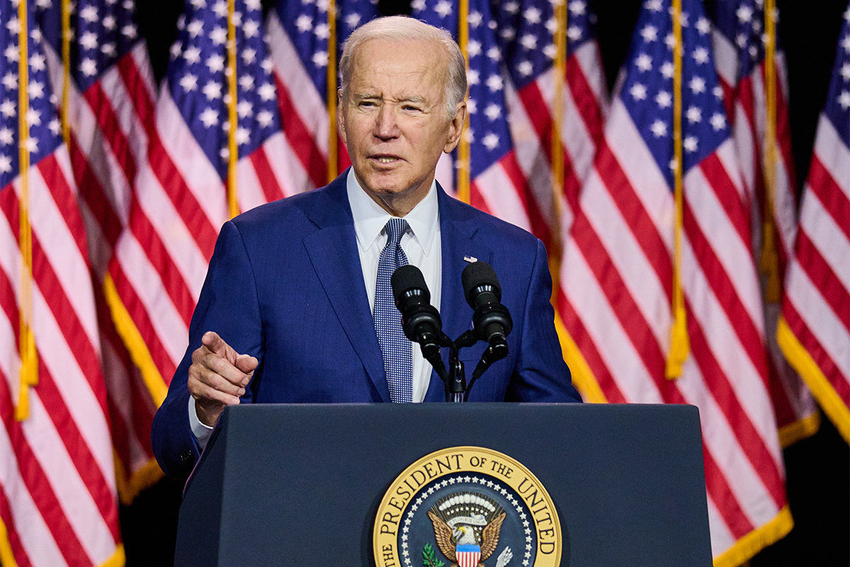 President Joe Biden giving a speech at a podium